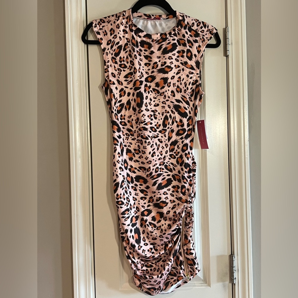 Sleeveless leopard . Light peach, black, orange pattern.